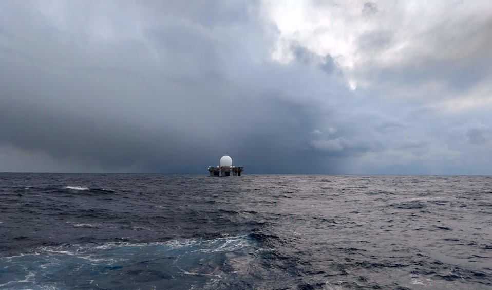 The Sea-Based X-Band Radar underway beneath storm clouds in the North Pacific
